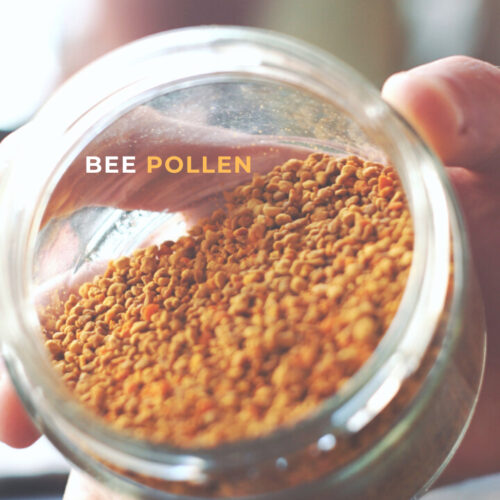 A jar of Bee Pollen held on its side with the open end facing the camera